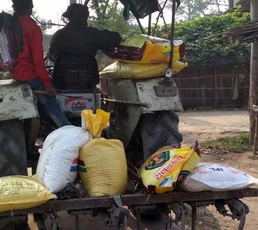 Farmer taking DeHaat agri input products on tractor